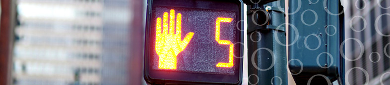 Crosswalk sign with hand showing five seconds.