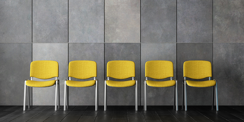 Empty Waiting Room With Yellow Chairs, Gray Color Granite Wall And Black Parquet Floor.