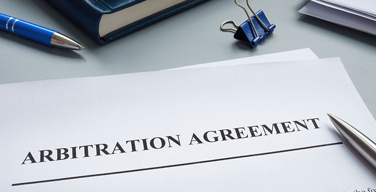 Papers with arbitration agreement and a pen