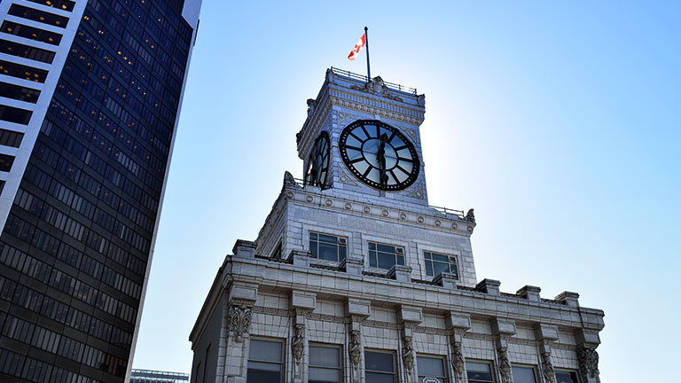 Closeup of the Vancouver Block building and clock tower in Vancouver, B.C., which is over 100 years old