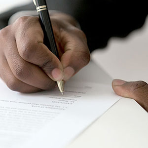 Person signing a document.
