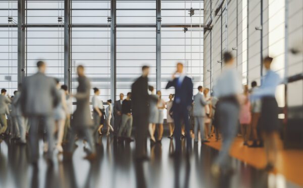 Large group of business people in convention centre, 3D generated image.